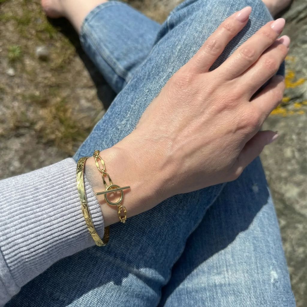 Frequency Paris-Ibiza Burning Desire gold T-bar bracelet styled with the So Hum bracelet for layered look