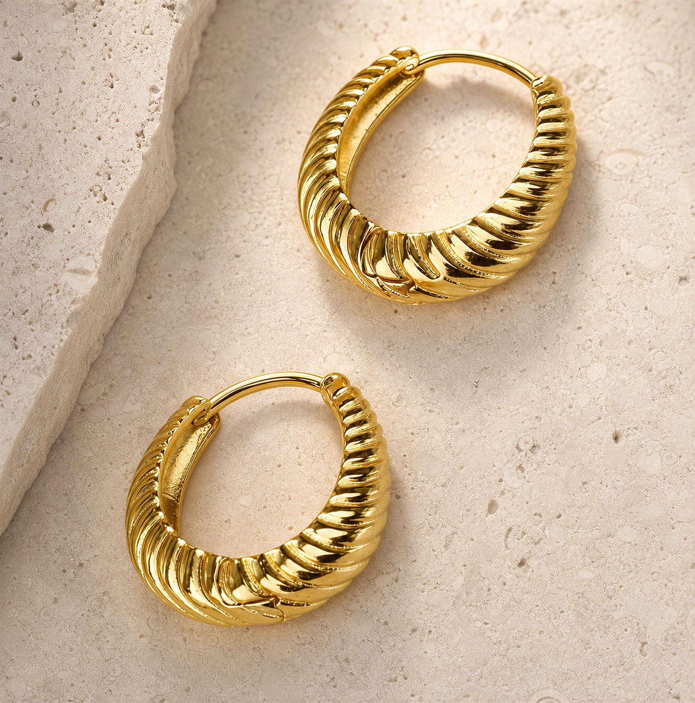Close-up of the Costes Gold Hoop Earrings by Frequency Paris-Ibiza showing detailed rope texture.