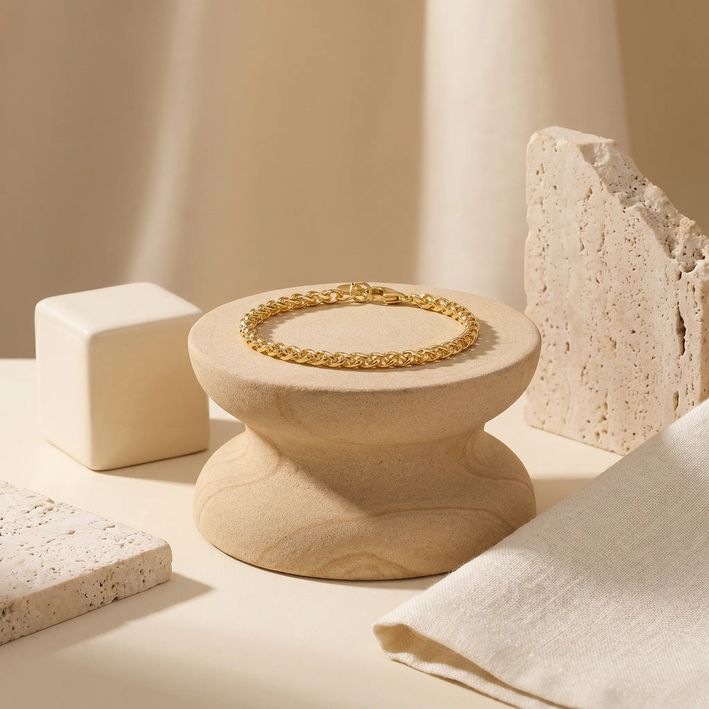 Frequency Paris-Ibiza Destiny Gold Chain Bracelet in a beautiful still life set up, close up showing interlocking spiga chain design and fine craftsmanship. Chic, elegant, stylish. A piece for everyday wear.