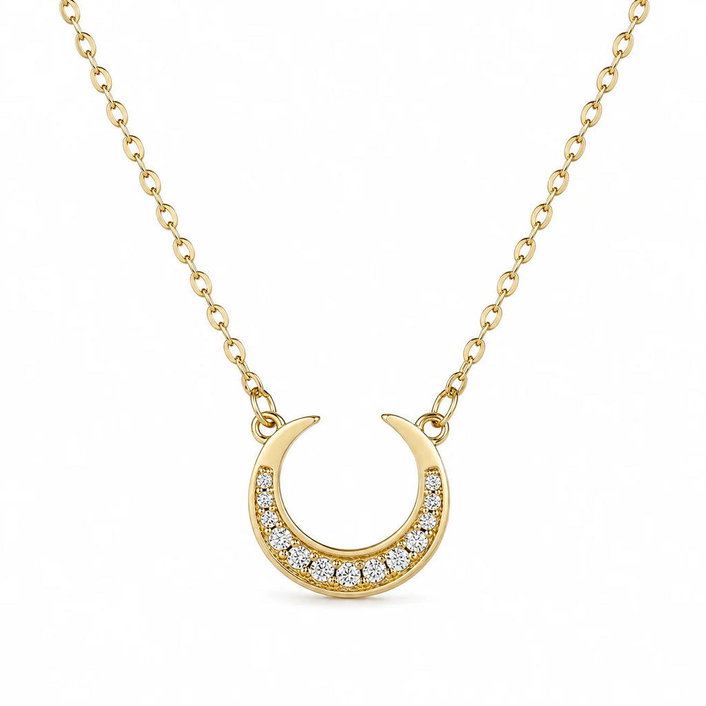 Dreamscape Gold Pendant Necklace by Frequency Paris-Ibiza — celestial crescent moon pendant with zircon crystals on white background, highlighting exquisite detail.