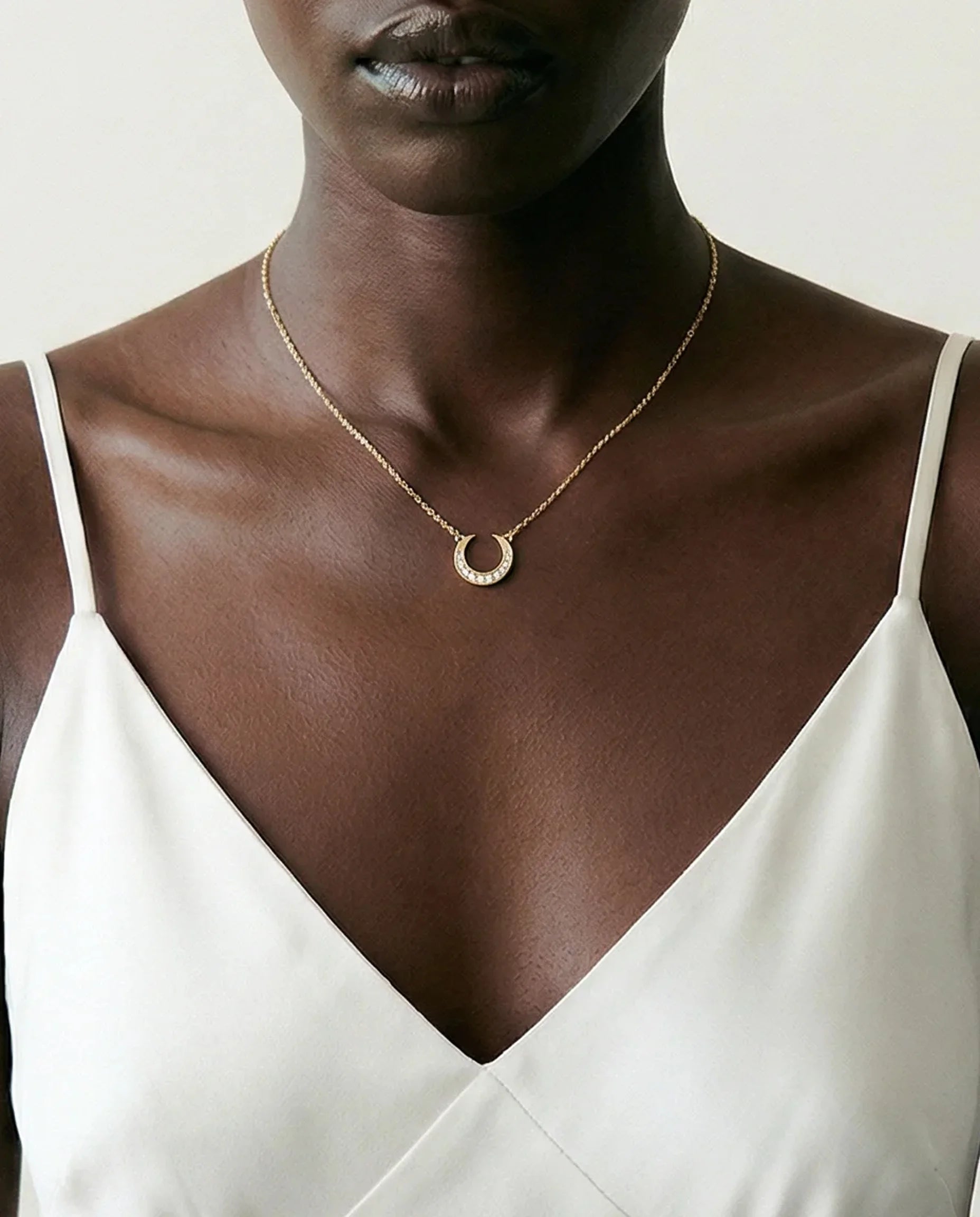 Closeup detail of the Dreamscape Pendant necklace by Frequency Paris-Ibiza. Available in two options: 18k Gold plated sterling silver or rhodium plated sterling silver, with zircon crystal accents. 