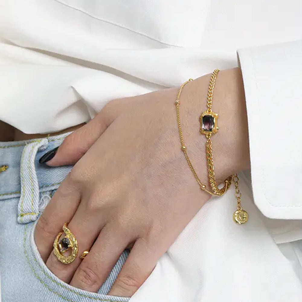 Frequency Paris-Ibiza Alchemy Chain Bracelet in gold worn with white blazer and blue jeans, luxury everyday styling
