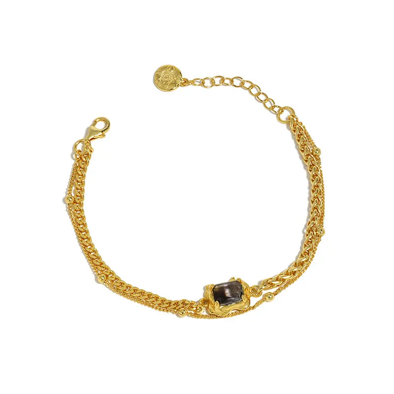 Frequency Paris-Ibiza Alchemy Chain Bracelet in gold against white background, dual chains and zircon detail