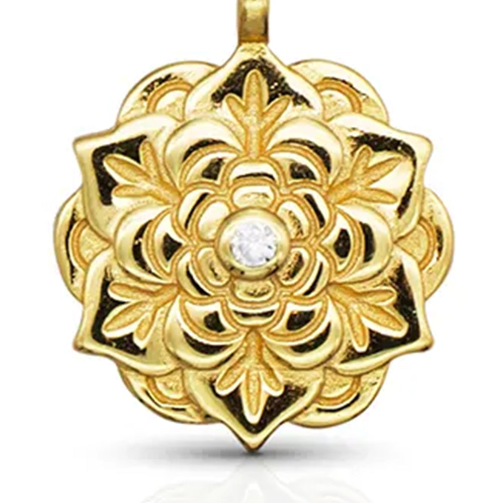 Close-up of Empowerment Gold Pendant Necklace showing floral design and central crystal on gold chain. Frequency Paris-Ibiza