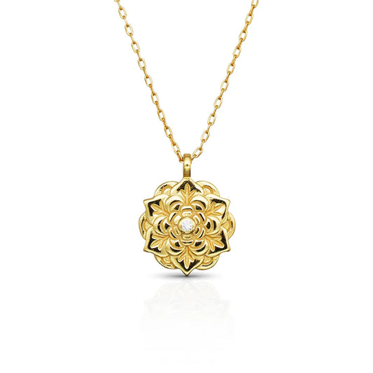 Empowerment Gold Pendant Necklace by Frequency Paris-Ibiza, on white background — floral design with central crystal on gold chain. 