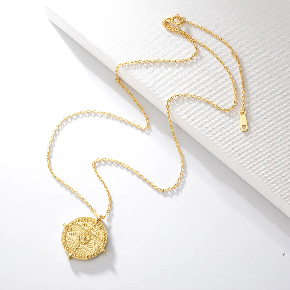 Es Vedrà gold pendant necklace detail, highlighting coin design, 18k gold plated sterling silver, talisman jewellery. Shop now at Frequency Paris-Ibiza