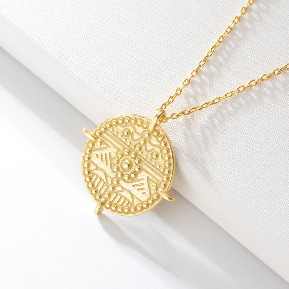 Close-up of Es Vedrà gold pendant necklace worn as a statement piece, radiating Ibiza energy and magnetic attraction. Frequency Paris-Ibiza