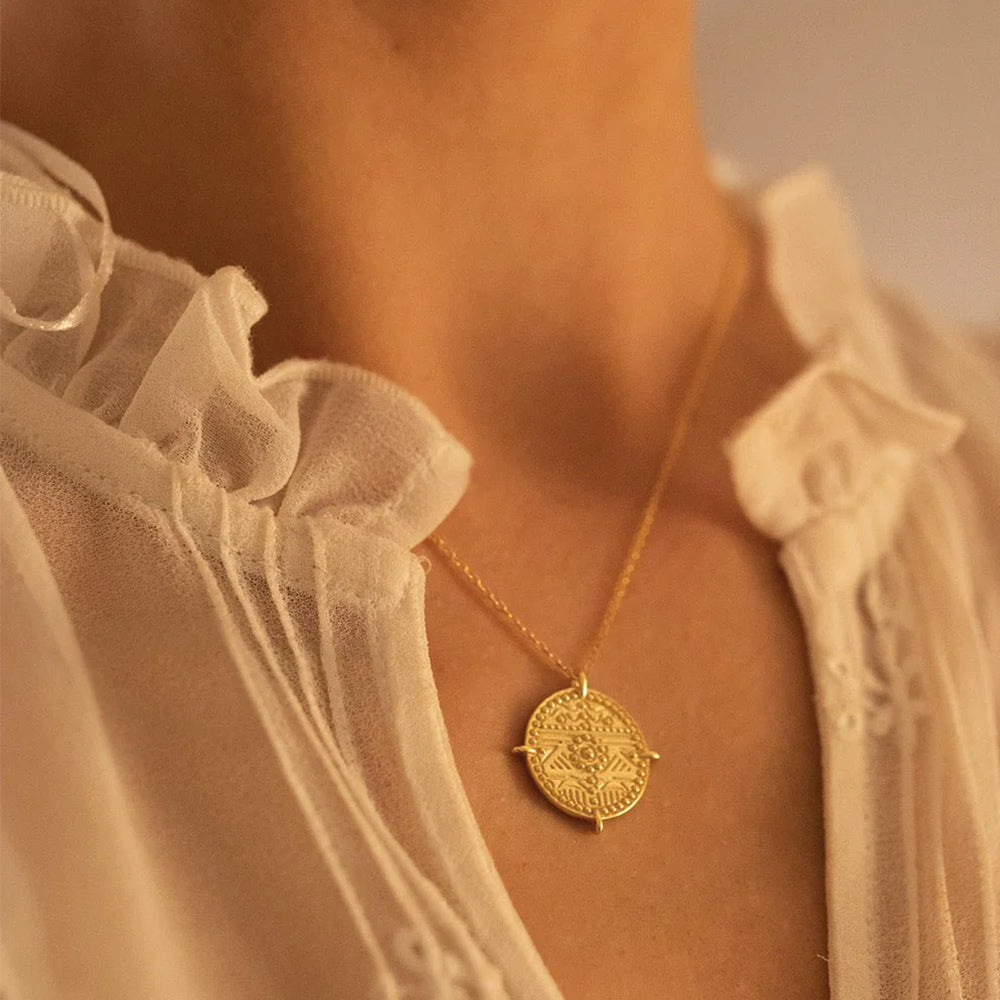 Close-up of Es Vedrà gold pendant necklace showing 18k gold plated sterling silver craftsmanship. Frequency Paris-Ibiza