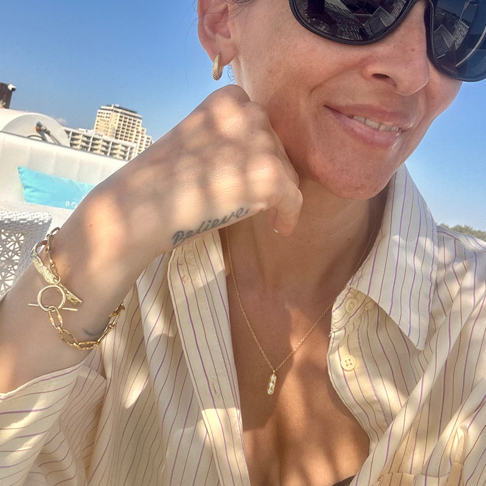 Stylish Guiding Light gold pendant necklace on a delicate chain, designed to remind women to trust their inner light. Frequency Paris-Ibiza