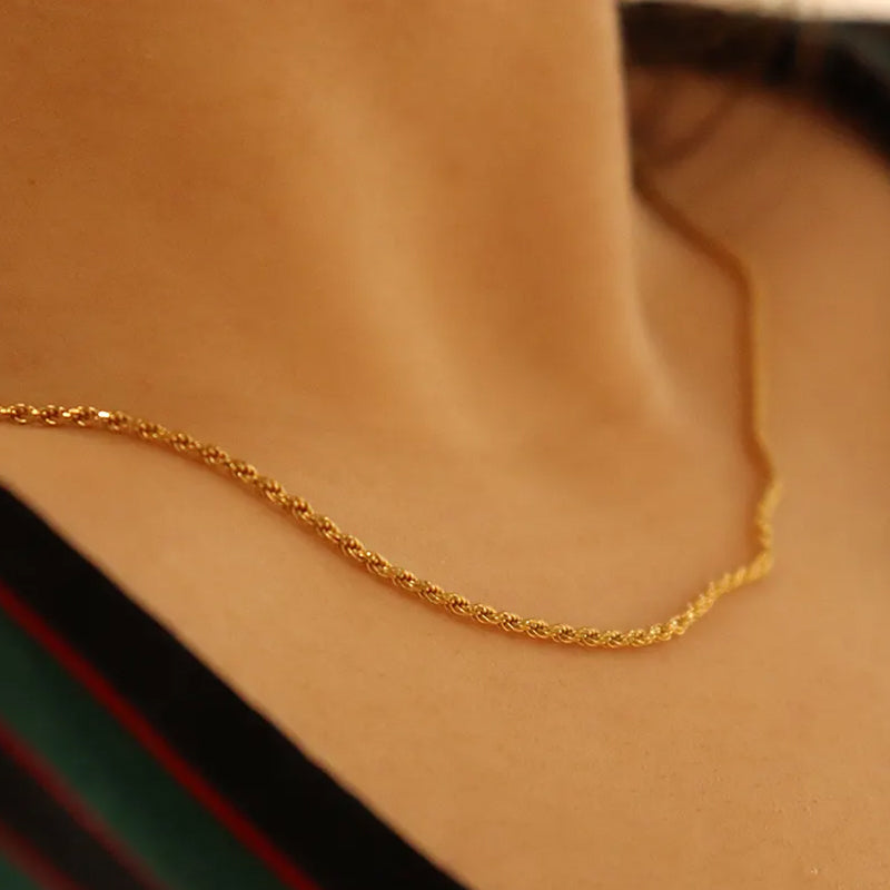 Positivity Gold Rope Chain Necklace close-up on model’s neck — versatile gold necklace that uplifts any outfit. Frequency Paris-Ibiza