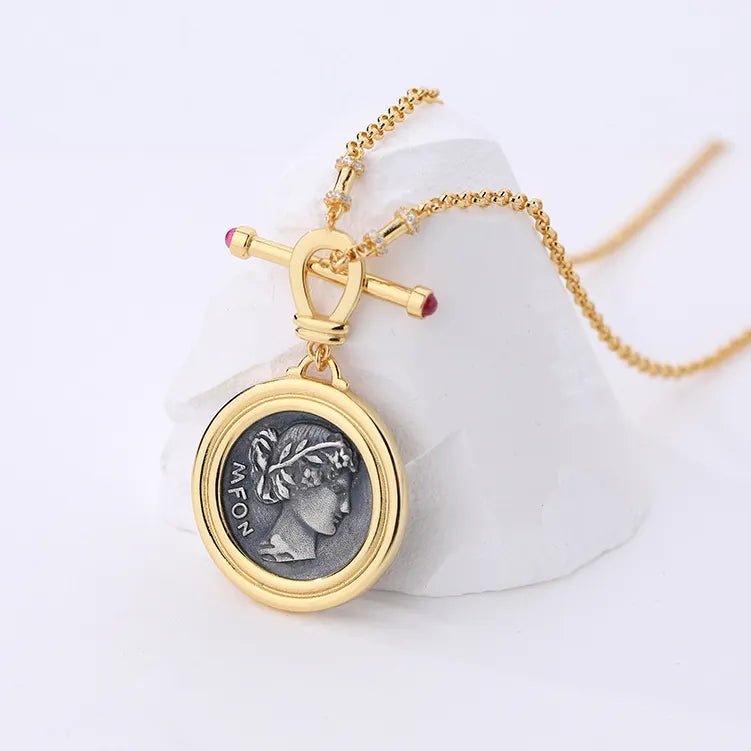 Soul Purpose Gold Pendant Necklace in grey coin finish — close-up detail of the pendant. Frequency Paris-Ibiza