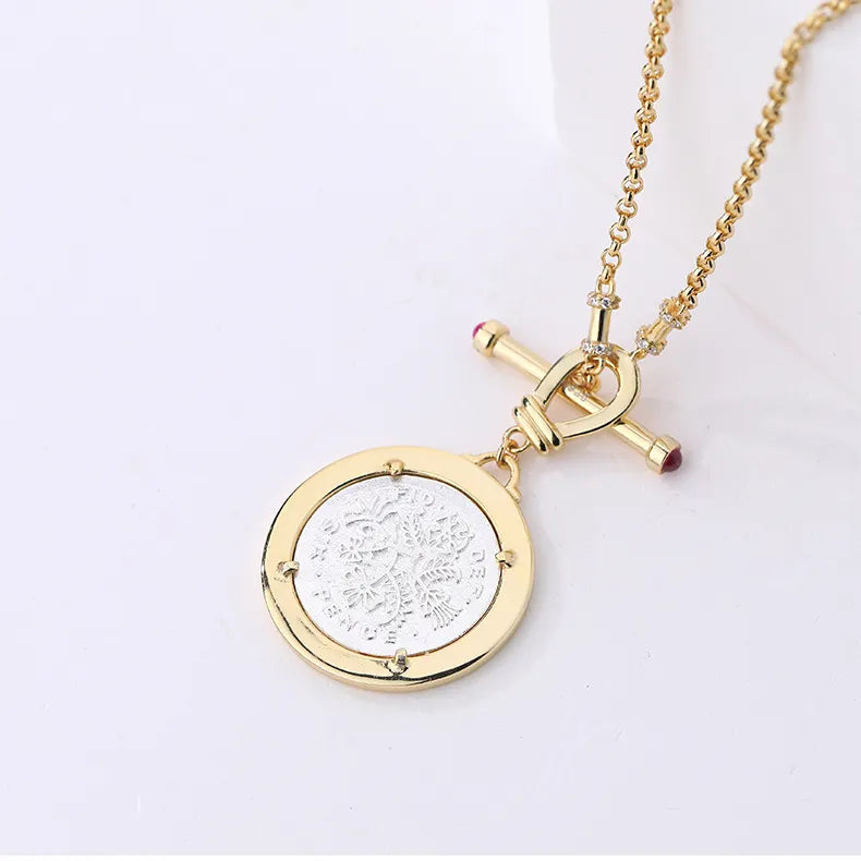 Back of Soul Purpose Gold Pendant Necklace in silver coin finish showing reversible motif. Frequency Paris-Ibiza