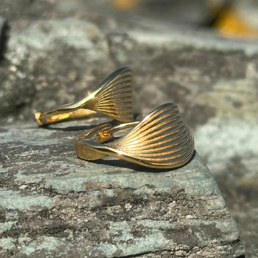 Side view of Frequency Paris-Ibiza Eternal Wave Gold Hoop Earrings, showcasing sculptural swirl and premium craftsmanship