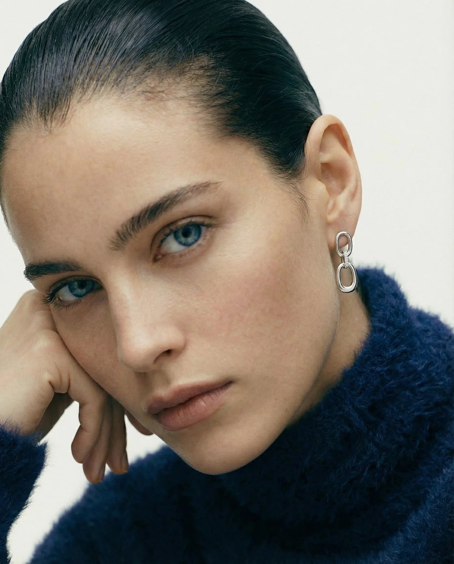 Model wearing Frequency Paris-Ibiza Power Drop Earrings in rhodium-plated sterling silver. Stunning drop earrings, perfect for both daytime and evening wear, showcasing elegant design and zircon accents.