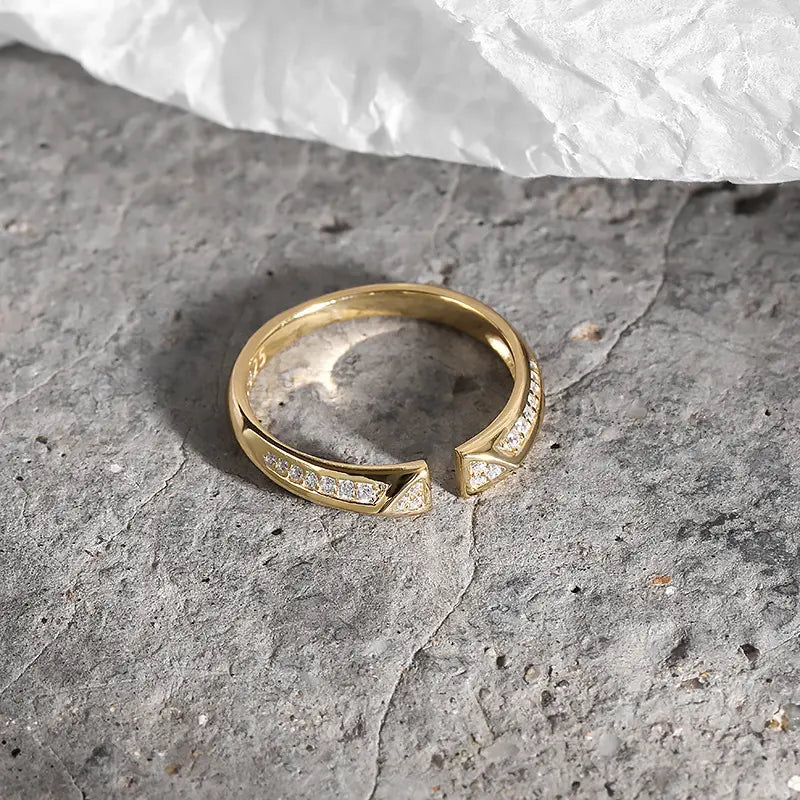 Close-up of the Frequency Paris-Ibiza Resonance Ring showing two triangle shapes with zircon crystals and crystal accents along the band, contemporary craftsmanship