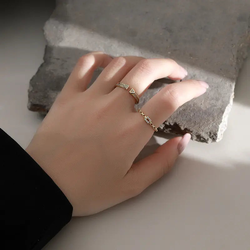 Model hand wearing the Frequency Paris-Ibiza Resonance Ring paired with another ring, elegant, chic, and beautifully styled