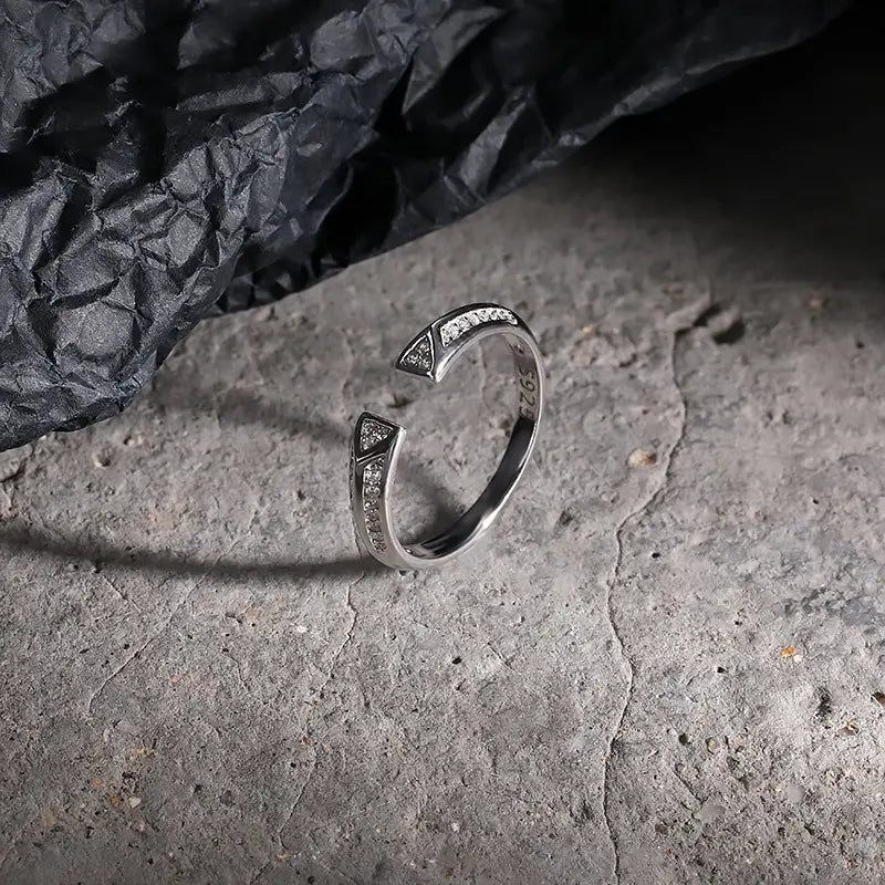 Close-up of the silver rhodium plated Frequency Paris-Ibiza Resonance Ring showing triangle crystal details and decorative crystals along the band