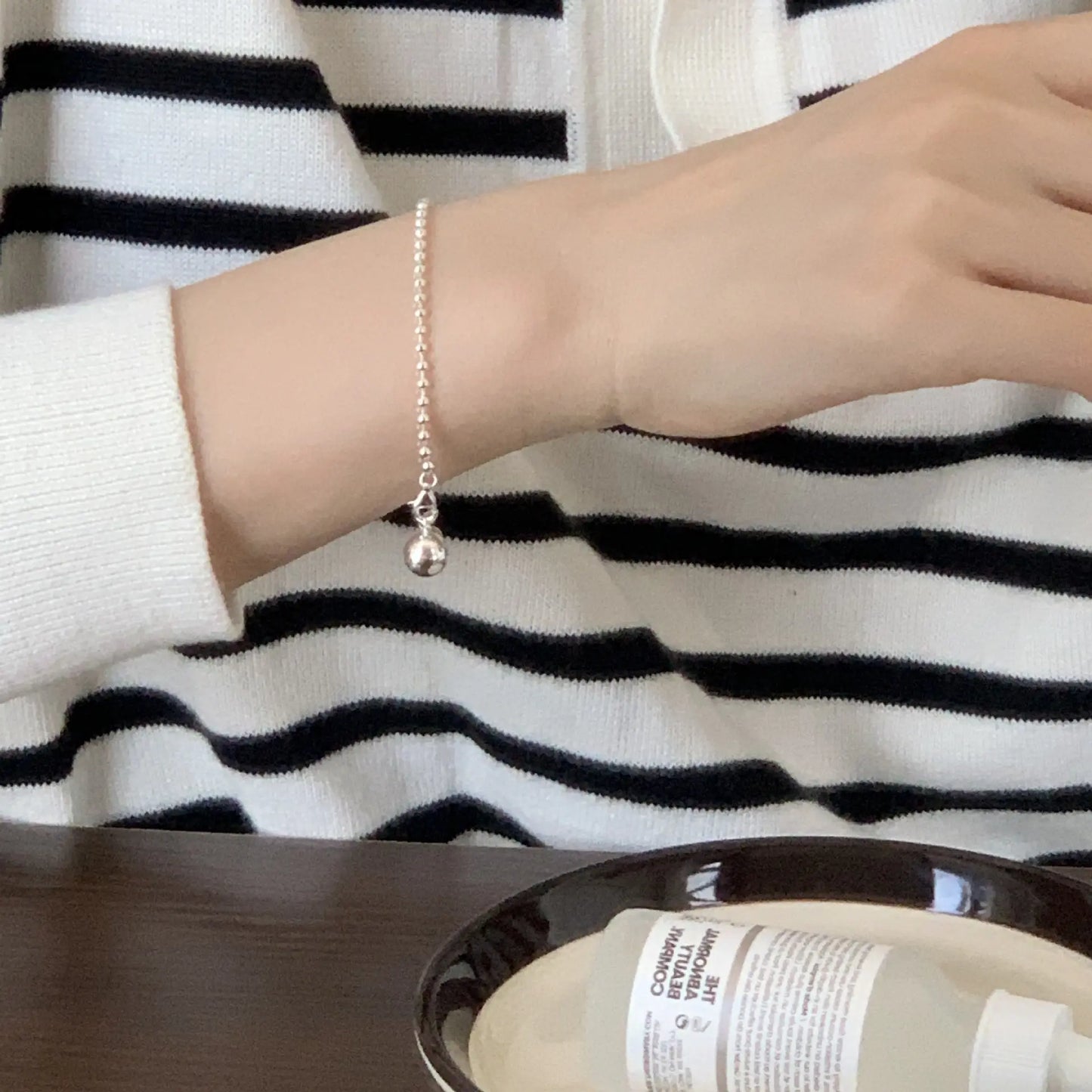 Silver Presence Beaded Chain Bracelet by Frequency Paris-Ibiza worn with casual chic look, highlighting drop bead detail and stylish minimalism.