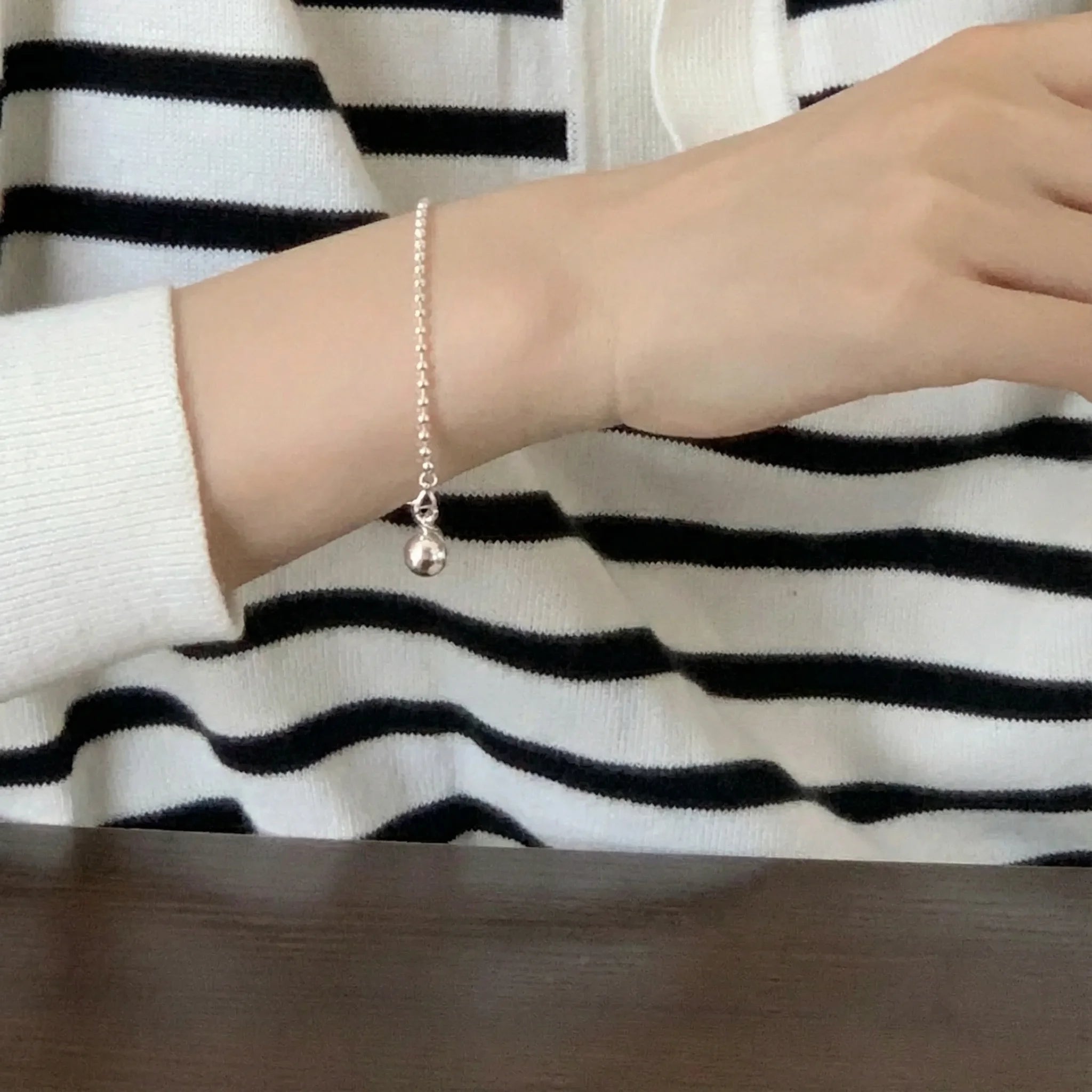 Silver Presence Beaded Chain Bracelet by Frequency Paris-Ibiza worn with casual chic look, highlighting drop bead detail and stylish minimalism.