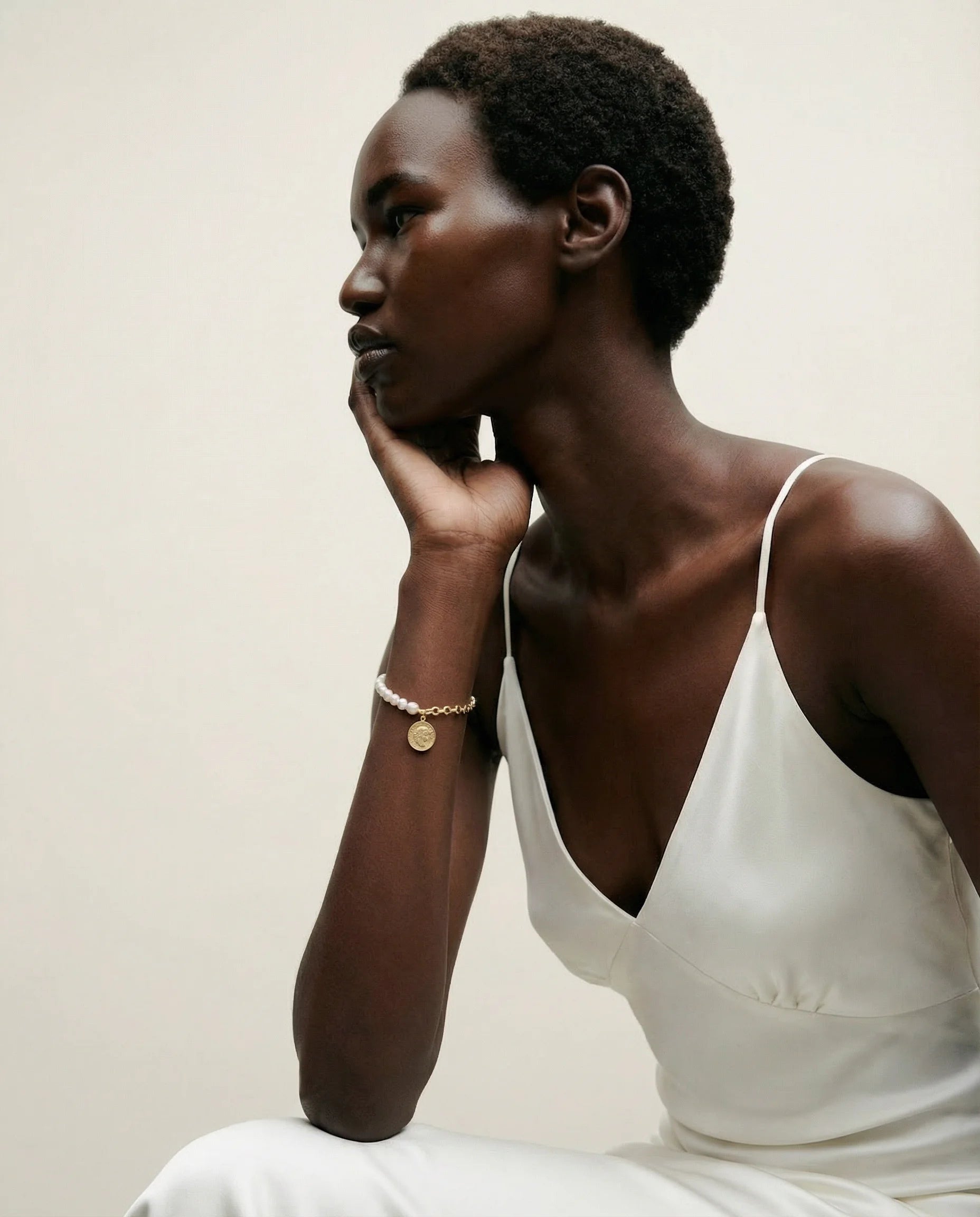 Wisdom Coin Charm Bracelet – 18k gold plated with slim bracelet worn with a delicate evening dress – Frequency Paris-Ibiza