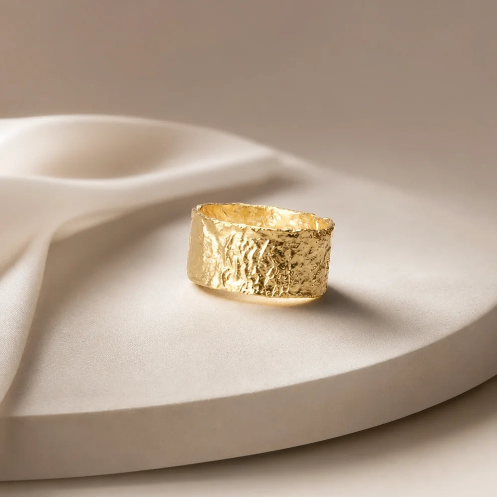 Gaia Ring by Frequency Paris-Ibiza resting on a bed of crystals, emphasising its connection to the raw beauty of nature. The hammered texture and adjustable design make it a perfect embodiment of grounded energy.