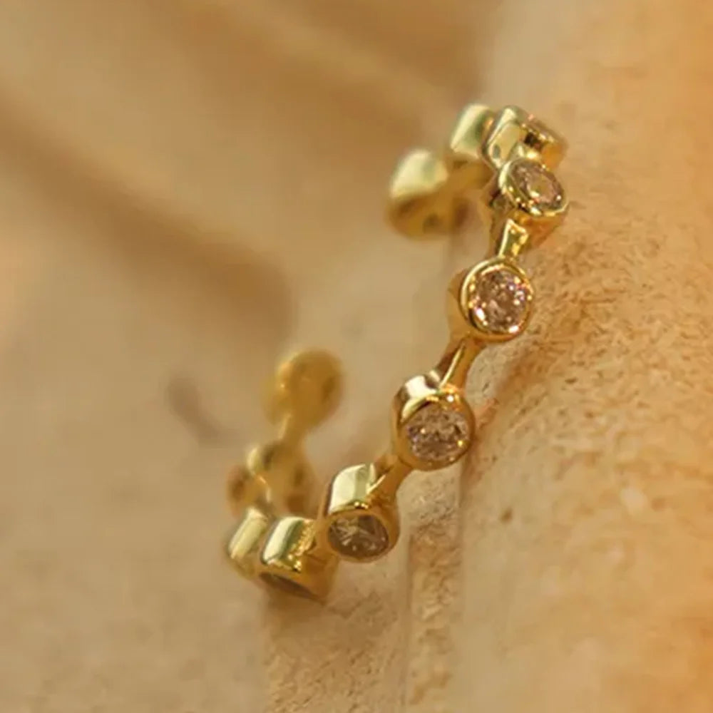 Gratitude Ring on white background, 18K gold plated sterling silver band with sparkling zircon crystal accents, stylish and intentional, Frequency Paris-Ibiza