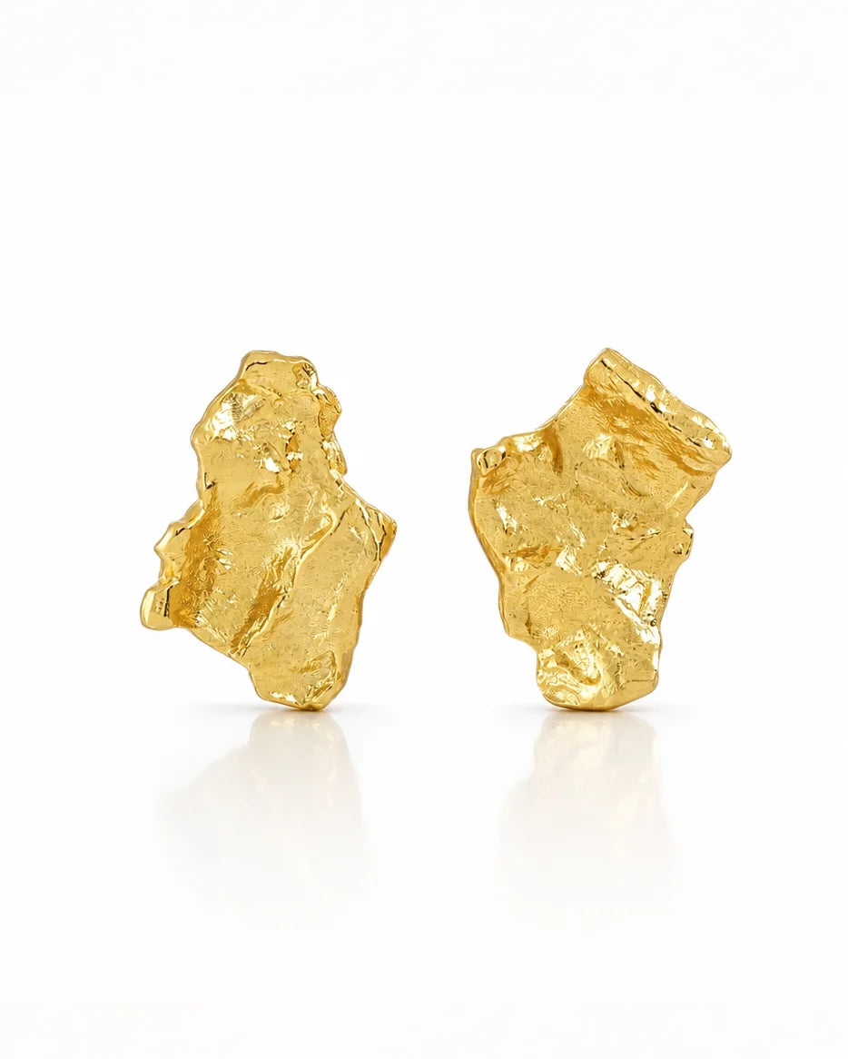 Grounding earrings in 18k gold-plated sterling silver with hammered, irregular design. Classic studs showcasing organic texture. Frequency Paris-Ibiza.