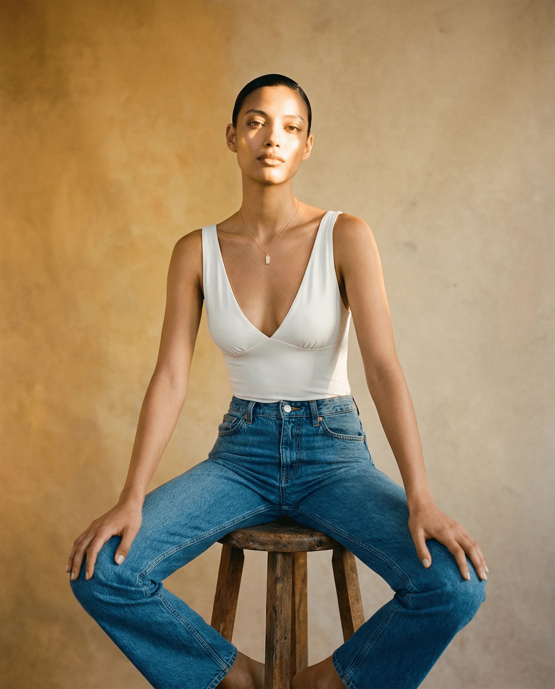 Frequency Paris-Ibiza's most gifted piece - The Guiding Light Gold Pendant Necklace - styled with a white bodice and blue jeans. The perfect piece to wear from day to night. 