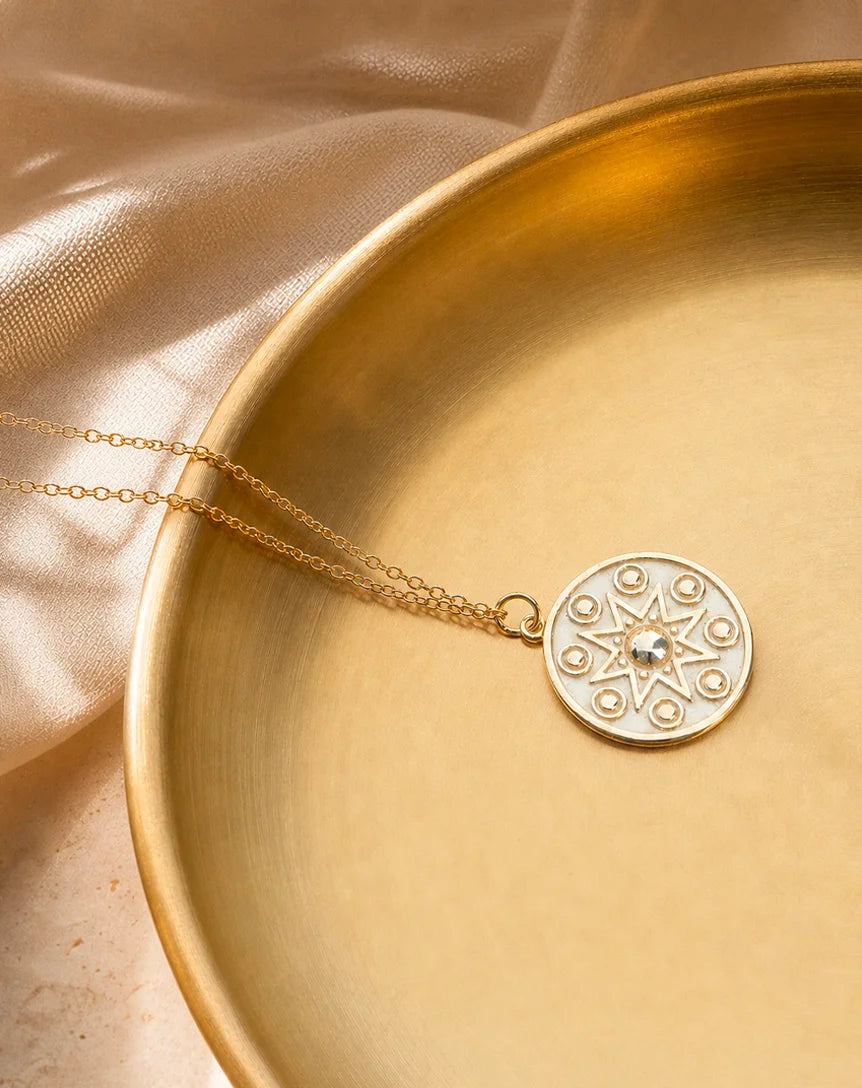 Manifest Gold Pendant Necklace by Frequency Paris Ibiza — softly resting on a gold bowl, reflecting light and intention in every polished detail.