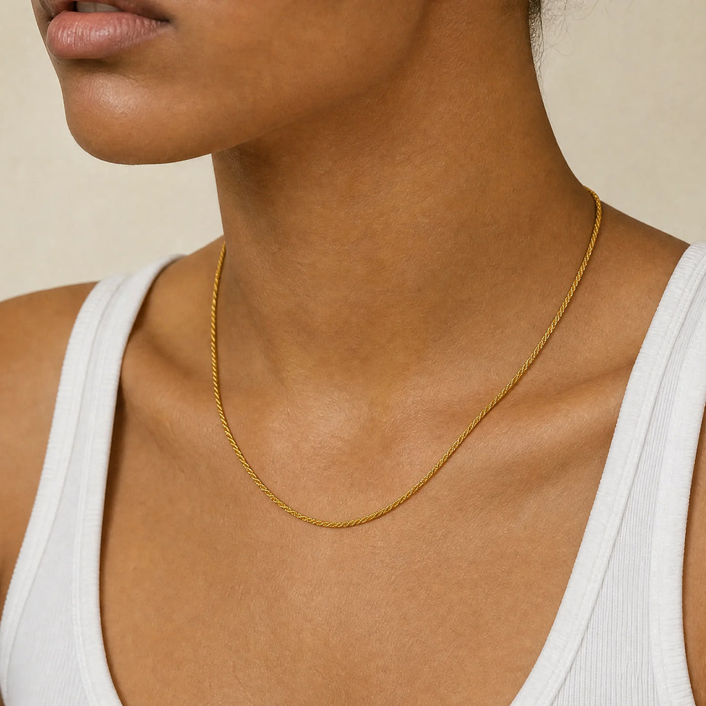 Positivity Gold Rope Chain Necklace by Frequency Paris-Ibiza stacked with a longer chain and worn with a cream blazer, adding style and sophistication to any outfit.
