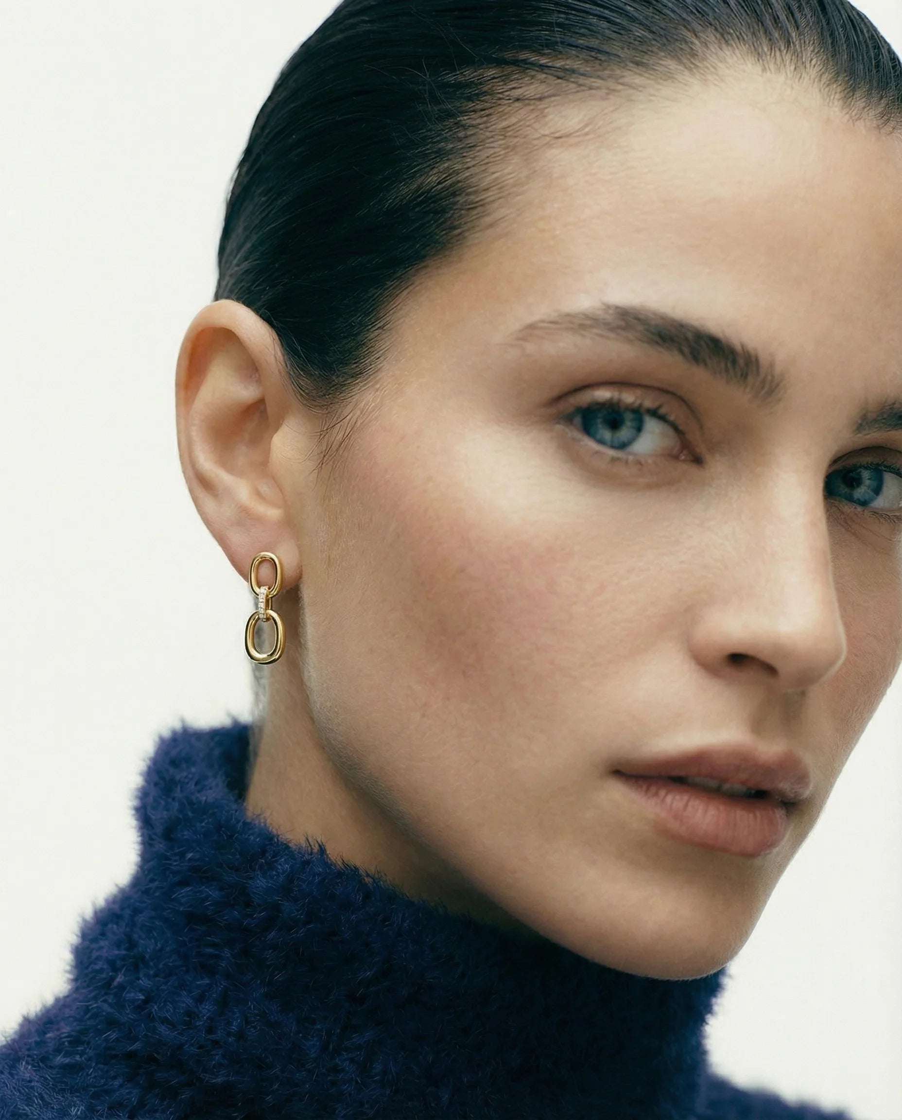 Model wearing Frequency Paris-Ibiza Power Drop Earrings in 18k Gold-plated sterling silver. Must-have drop earrings, showcasing elegant design and zircon accents. Your new favourite pair - wear them for casual days or evening events, 