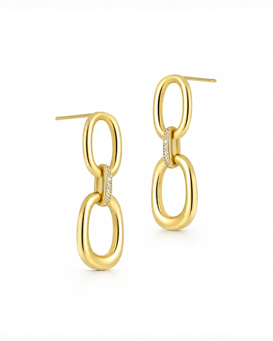 Frequency Paris-Ibiza Power Drop Earrings in 18K gold-plated sterling silver. Two oval hoops joined with a zircon crystal chain link. Elegant, stunning statement drop earrings on a white background.