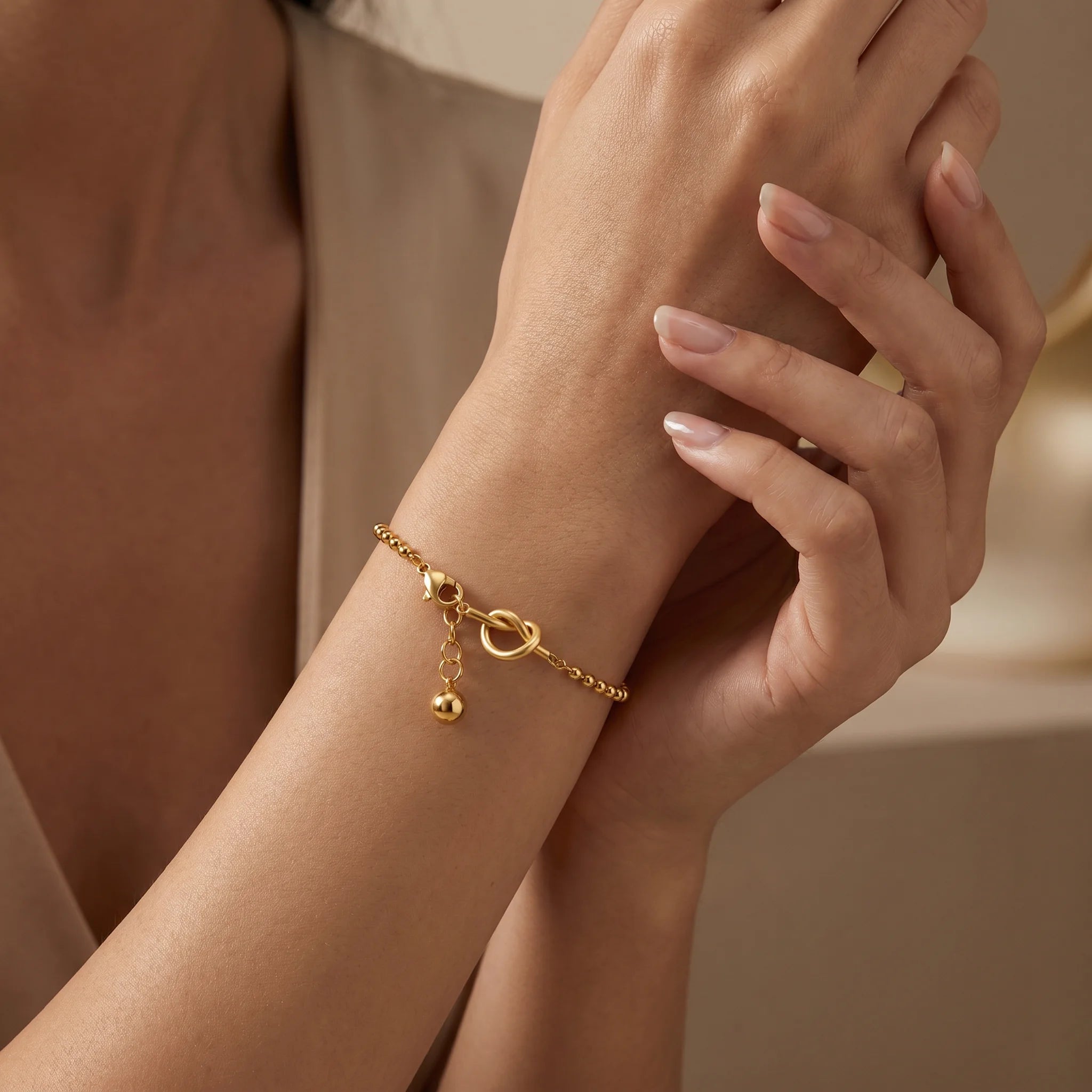 Close-up of Frequency Paris-Ibiza Gold Presence Beaded Chain Bracelet showing drop bead detail and interlocking decorative links.