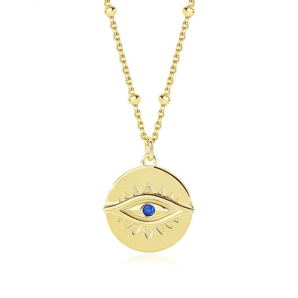 Protection Gold Pendant Necklace by Frequency Paris-Ibiza on white background – 18K gold plated sterling silver with gemstone eye detail. Frequency Paris-Ibiza