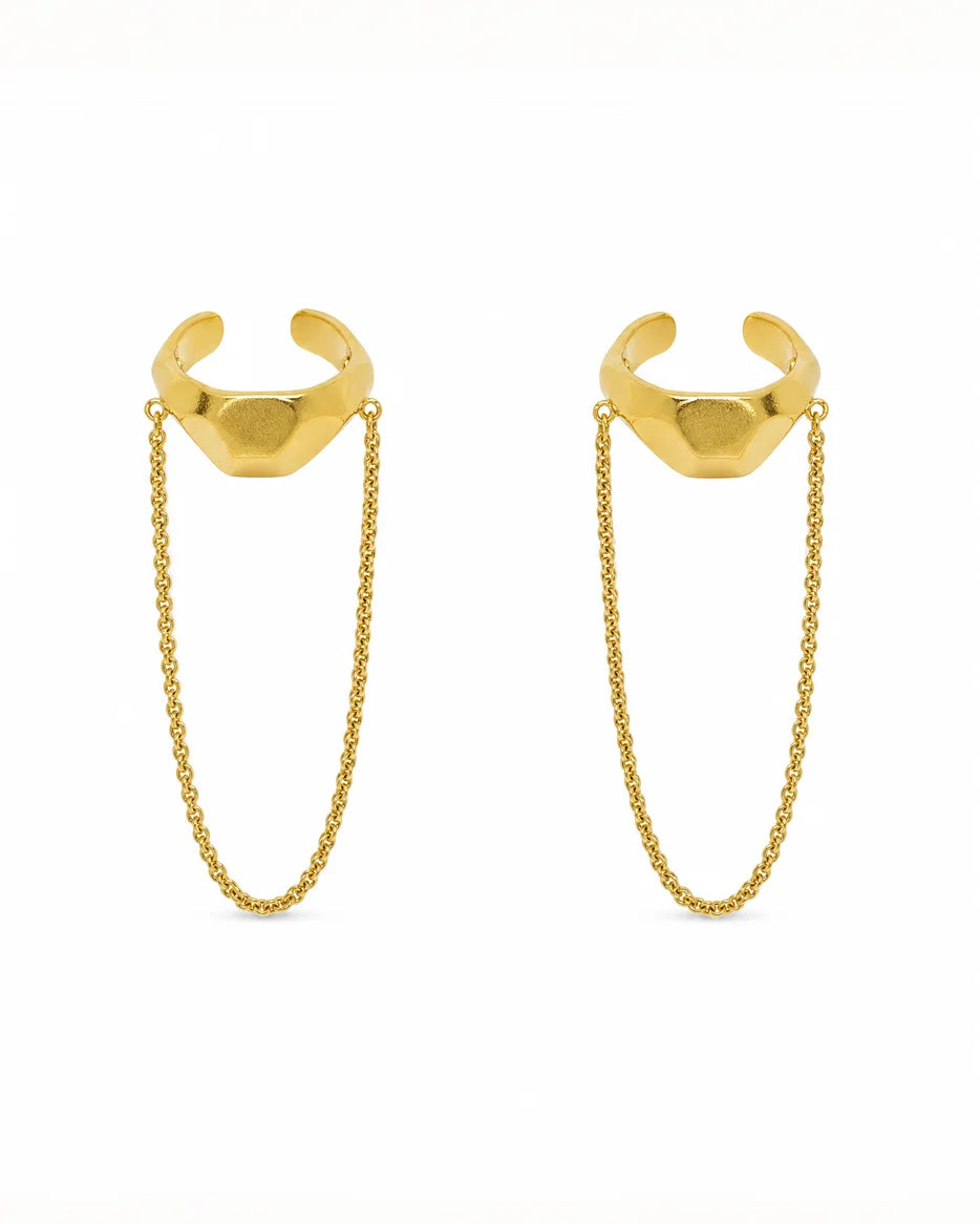Close-up of Frequency Paris-Ibiza Quantum Ear Cuff in 18K gold-plated sterling silver on a white background. Sleek and edgy design with chain drop detail.