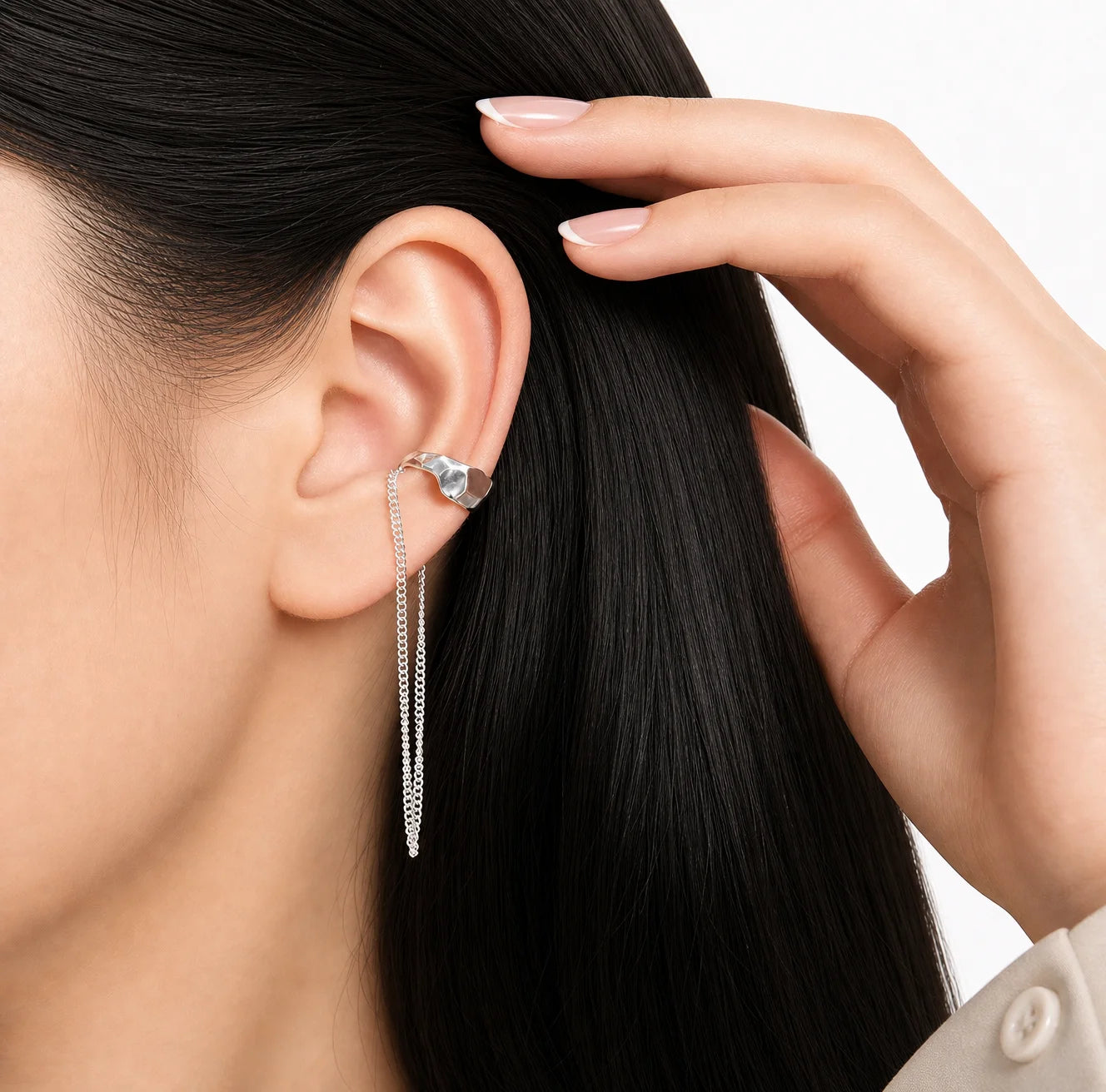 Frequency Paris-Ibiza Quantum Ear Cuff in rhodium-plated sterling silver worn on the ear. Highlights excellent craftsmanship, hammered texture, and elegant chain drop for an edgy statement.