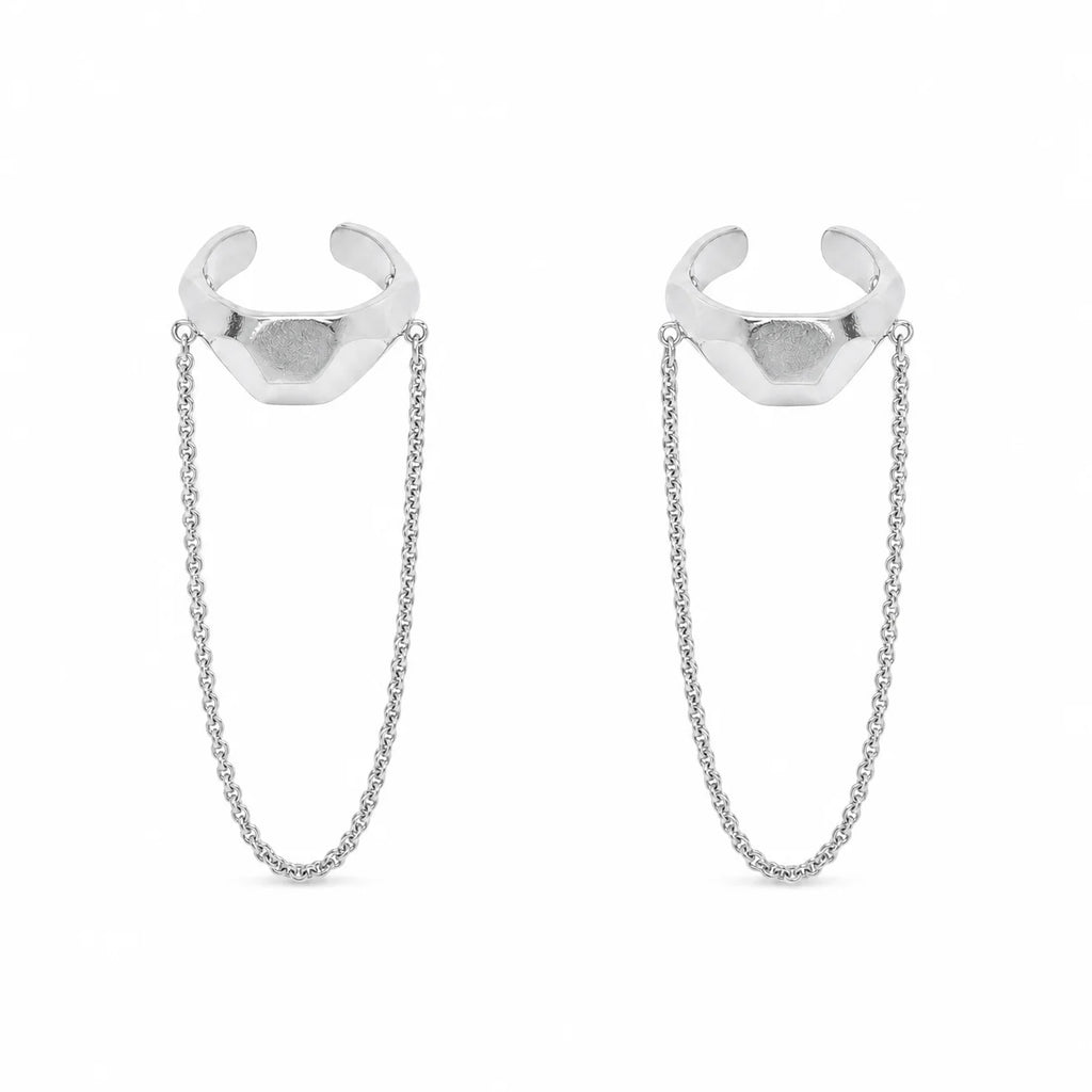 Close-up of Frequency Paris-Ibiza Quantum Ear Cuff in rhodium-plated sterling silver. Shows detailed craftsmanship, hammered texture, and edgy chain drop design.