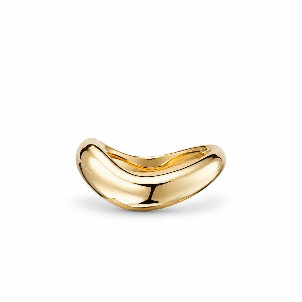 Close-up of the Stillness Ring by Frequency Paris-Ibiza showing the fluid sculptural design from one side in 18K gold plated sterling silver.