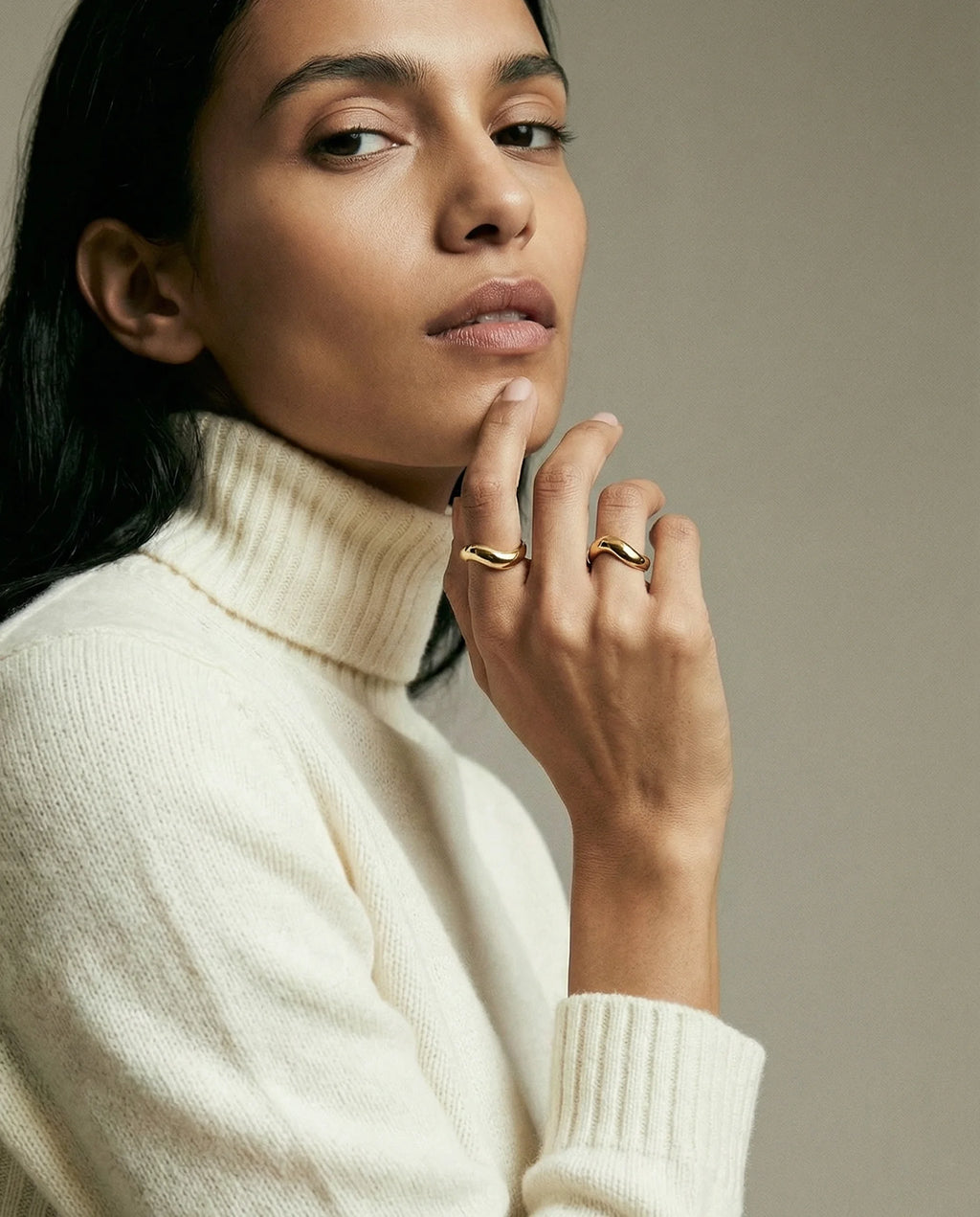 Model wearing two Stillness Rings by Frequency Paris-Ibiza. Fluid, sculptural design. Elegant, chic, intentional, and stylish 18K gold plated sterling silver.