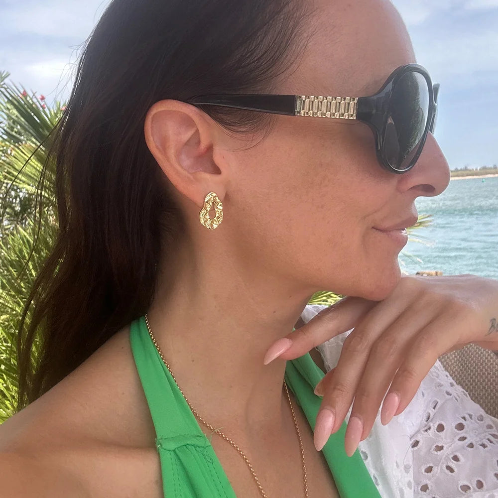 Side profile of the Brilliance stud earrings in 18k gold-plated sterling silver by Frequency Paris-Ibiza, showing an organic shape and hammered texture — the perfect earring for day-to-night wear.