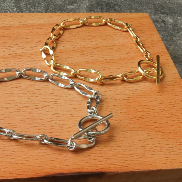 Gold and silver Burning Desire T-bar bracelets by Frequency Paris-Ibiza showing chunky chain detail