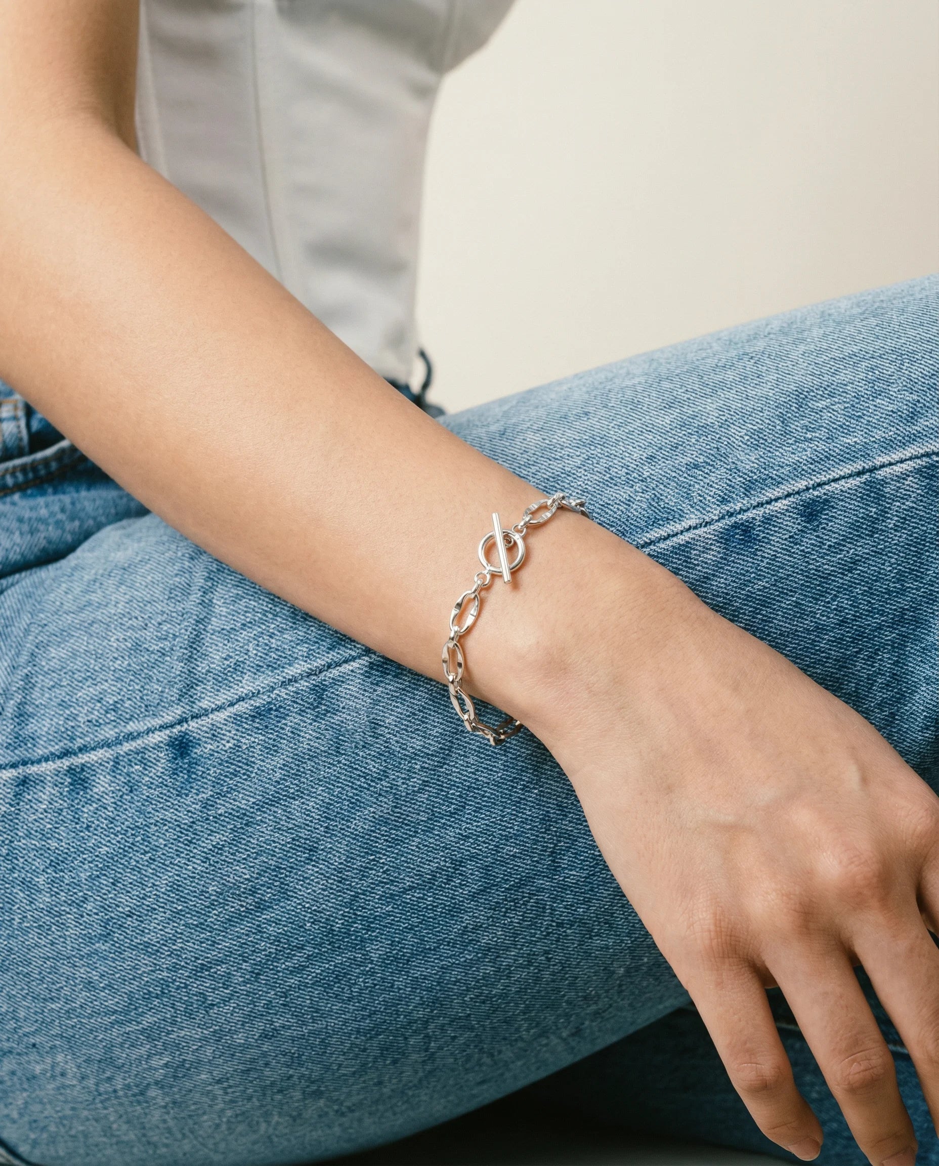 Frequency Paris-Ibiza Burning Desire silver T-bar bracelet worn on wrist showing polished chain design