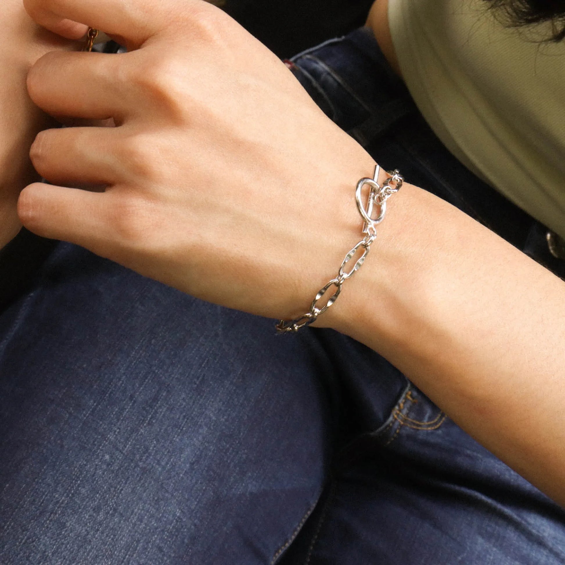 Frequency Paris-Ibiza Burning Desire silver T-bar bracelet worn on wrist showing polished chain design