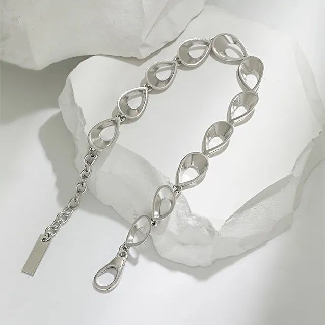 Rhodium plated Light Codes bracelet by Frequency Paris-Ibiza displayed on organic rock highlighting sculptural organic shapes