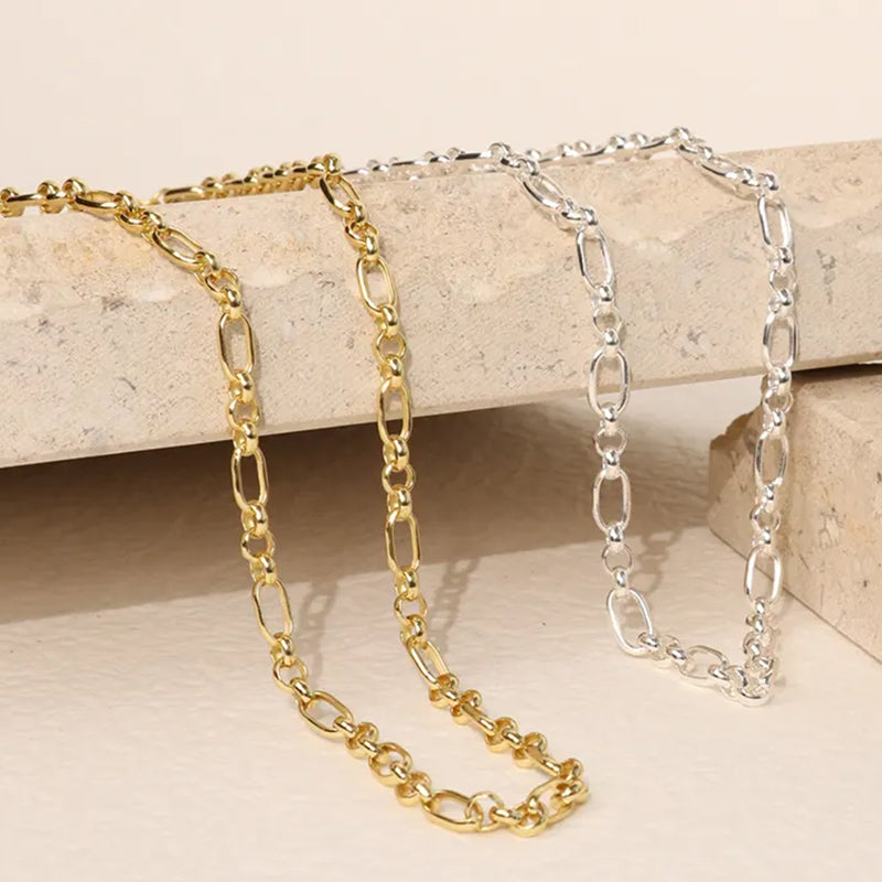 Close-up of Majestic Chain Necklaces in gold and silver finishes showing detailed chain links and refined craftsmanship. Frequency Paris-Ibiza