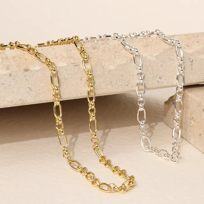 Close-up of Majestic Chain Necklaces in gold and silver finishes showing detailed chain links and refined craftsmanship. Frequency Paris-Ibiza