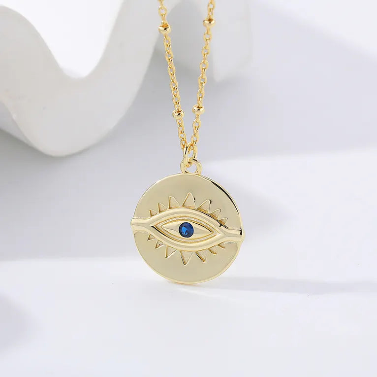 Close-up of Protection Gold Pendant Necklace by Frequency Paris-Ibiza showing gemstone eye detail and 18K gold plated sterling silver finish. Frequency Paris-Ibiza