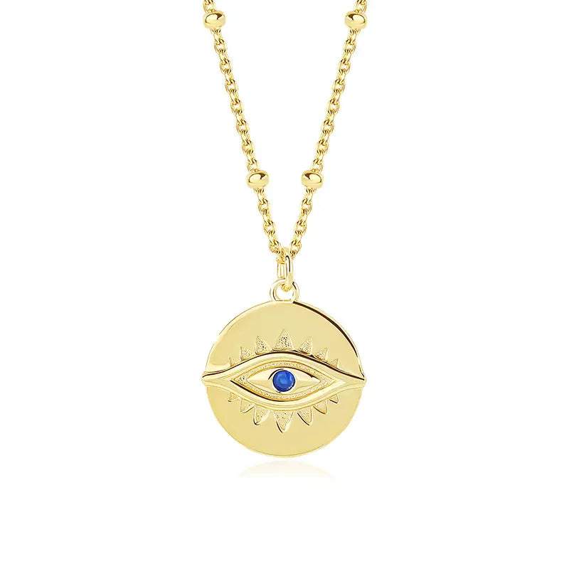 Protection Gold Pendant Necklace by Frequency Paris-Ibiza on white background – 18K gold plated sterling silver with gemstone eye detail. Frequency Paris-Ibiza