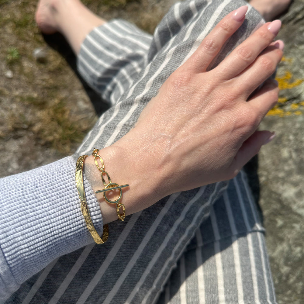 Frequency Paris-Ibiza So Hum gold cuff bracelet stacked with Burning Desire T-Bar Bracelet for layered, elegant look