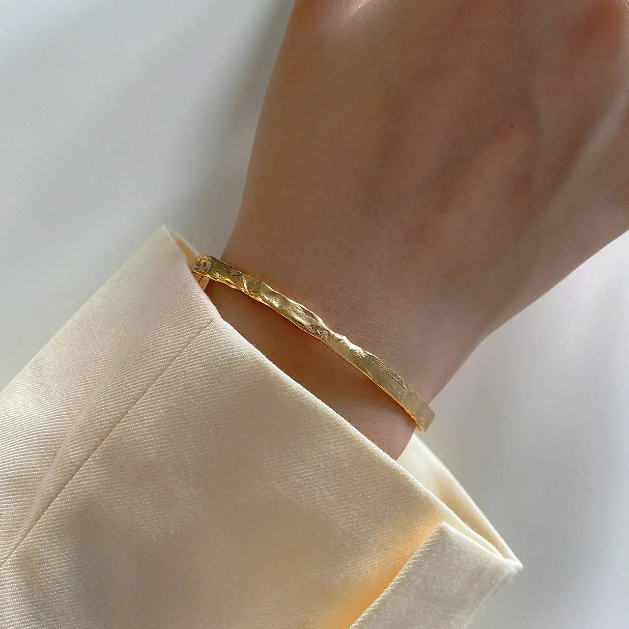 Frequency Paris-Ibiza So Hum gold cuff bracelet worn with elegant blazer for polished, luxe bohemian style